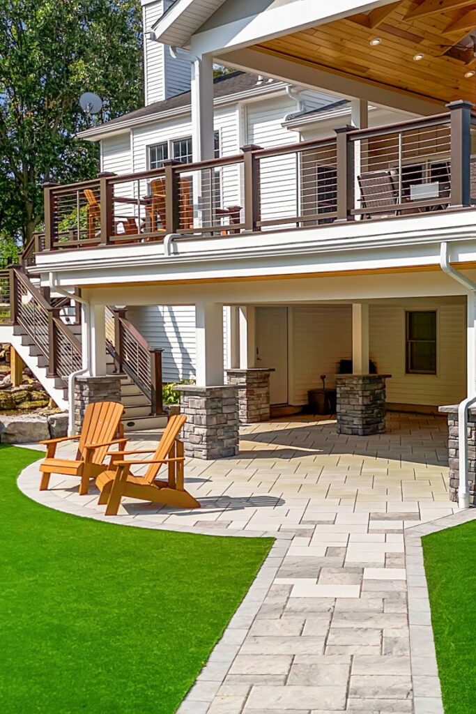 Lower-level patio seating area with pavers and multi-level deck in Clarence New York backyard